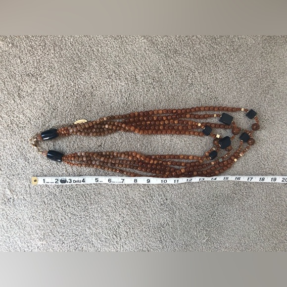 Multi strand necklace of amber colored beads, with navy blue and gold accents - Picture 4 of 4